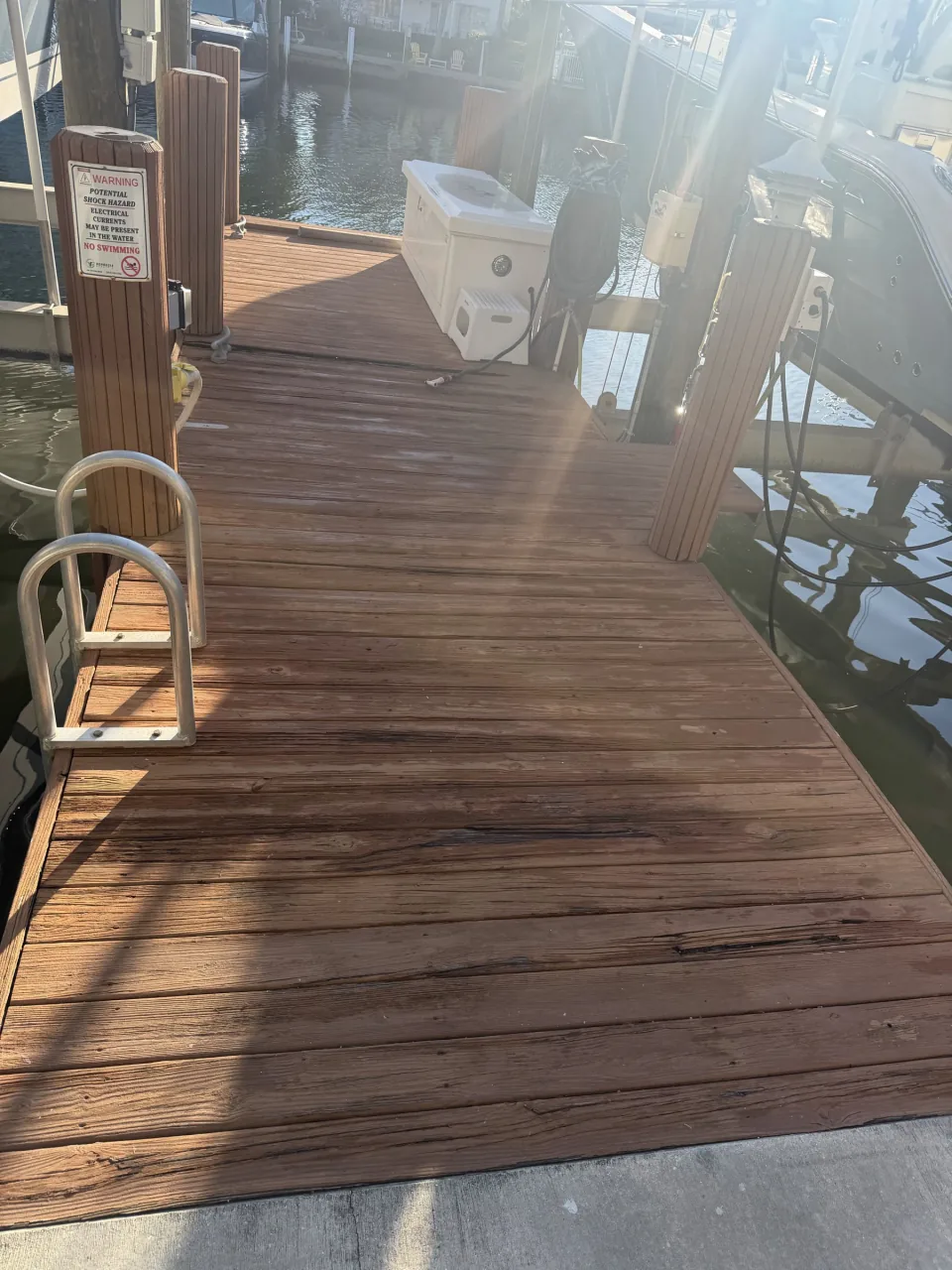 Weathered wood deck behind a house before removal