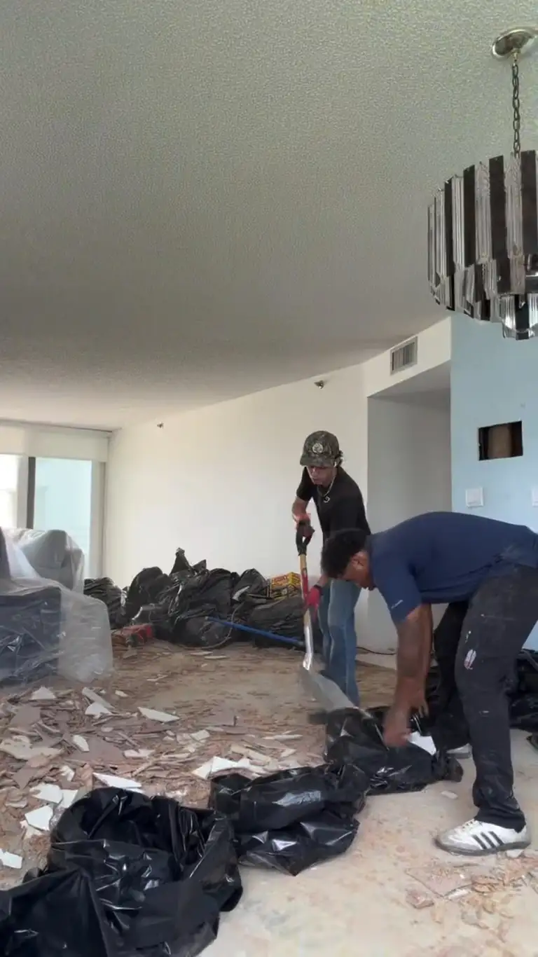 Crew bagging debris in the condo