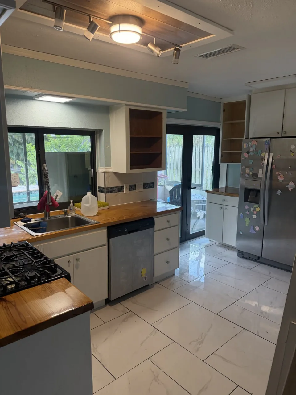 Gutted kitchen with cabinets and countertops removed and the floor swept after an interior tear-out