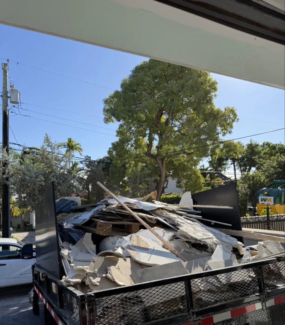 Bagged interior demolition debris carried out to the truck