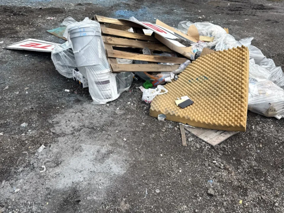 Active remodel site with stacked debris before a scheduled pickup