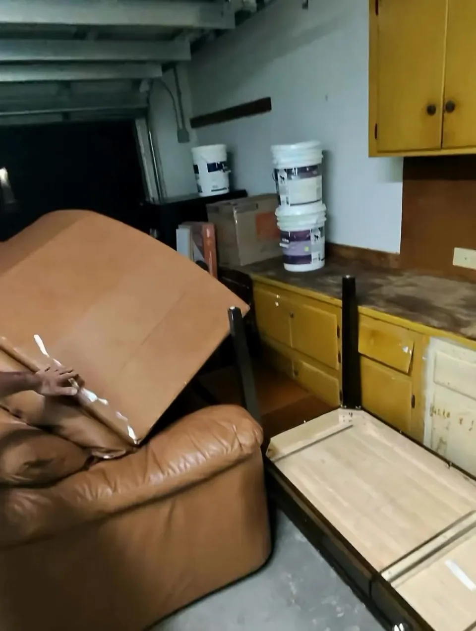 Furniture staged in a garage, ready for loading