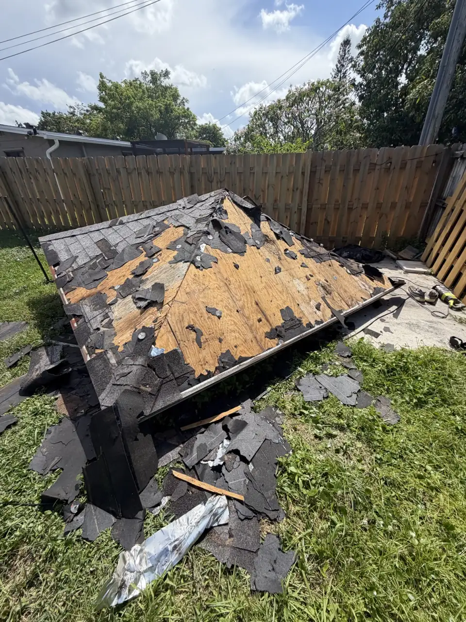 Crew member walking up to an old backyard shed before it is torn down