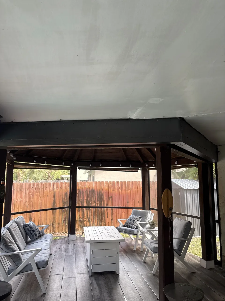 Old backyard shed with the door open and items being carried out