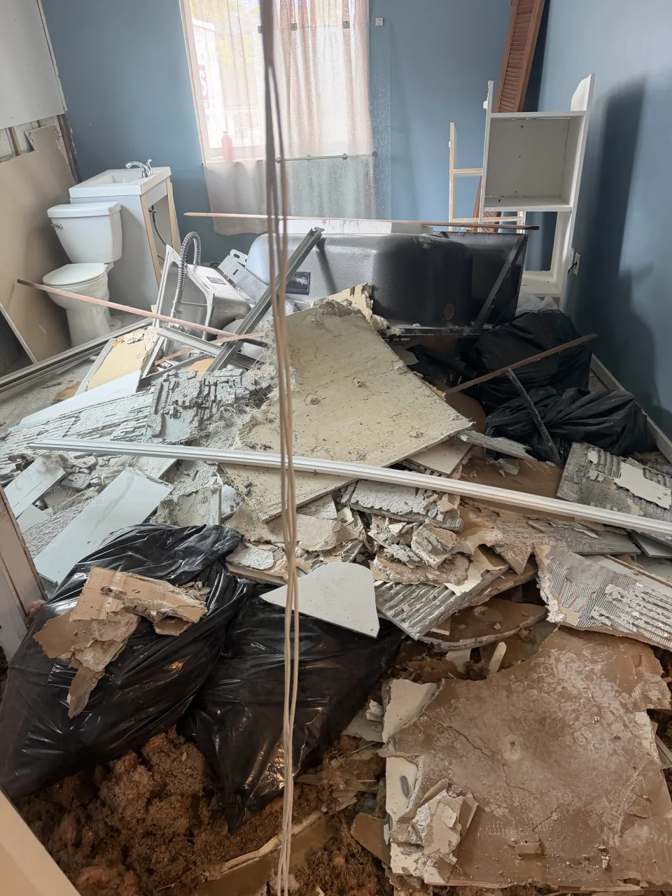 Bathroom gutted, tile and drywall bagged