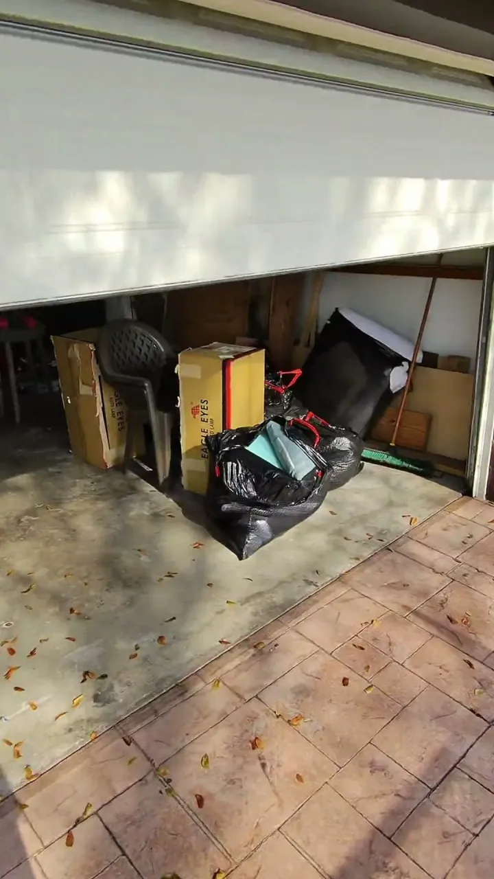 Time-lapse of a garage being emptied and the junk loaded onto the truck